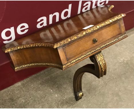 A Regency style walnut and gilt metal mounted wall bracket 