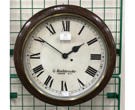 An early 20th Century oak circular wall clock, bearing G. Rushbrooke London inscription
