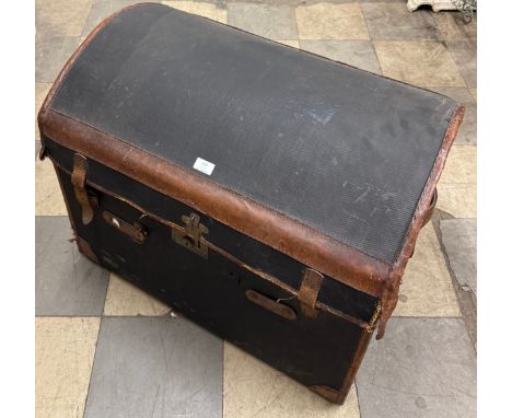 An early 20th Century leather bound dome topped trunk 