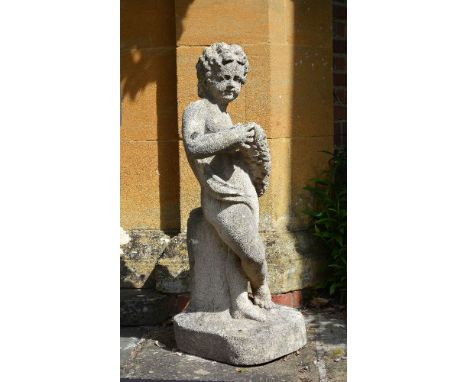A sculpted stone model of a putto, 19th century, portrayed standing and nude but for light drapery across his loins, a fruiti