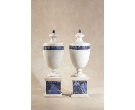 A pair of white marble and lapis lazuli mounted urns in Neoclassical style, each with knopped and waisted finial to an ovoid 