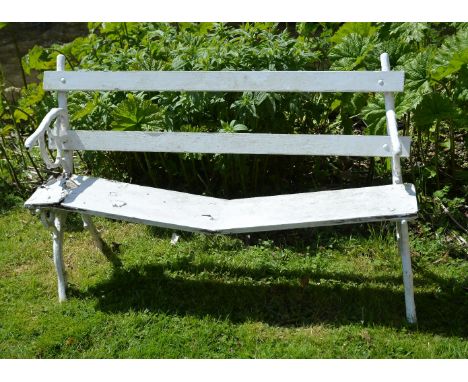A painted wood and cast iron garden bench, early 20th century, the slatted seat and backrest with scrolled armrests and confo