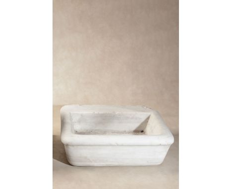 A rectangular white marble wall basin, probably Continental, 18th/ 19th century, the front and sides with simple everted rim,