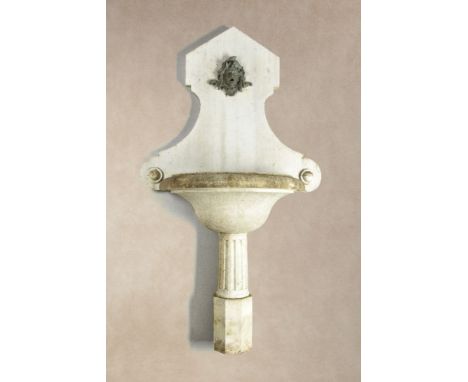 A Continental, probably Italian carved white marble wall fount and basin, late 19th / early 20th century, the backplate with 