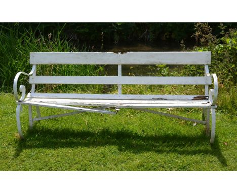 A painted wrought iron and slatted wood garden bench, early 20th century, with scrolled armrests   76cm high, 178cm wide
