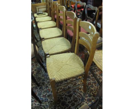Set of six oak ladder back type kitchen chairs with rush seats. (6)
