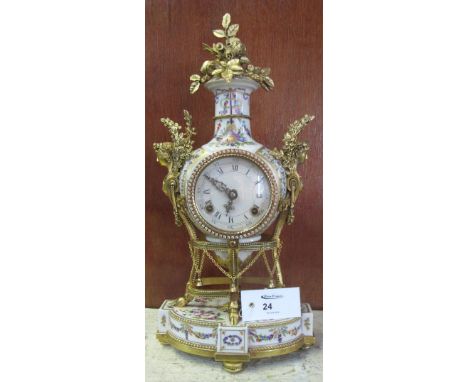 French porcelain balloon clock with gilt metal foliate and figural mounts and white enamel face with Roman numerals. Two trai