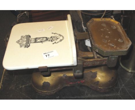 Set of cast metal, 'British Made' shop scales with ceramic platform, having transfer printed figure.