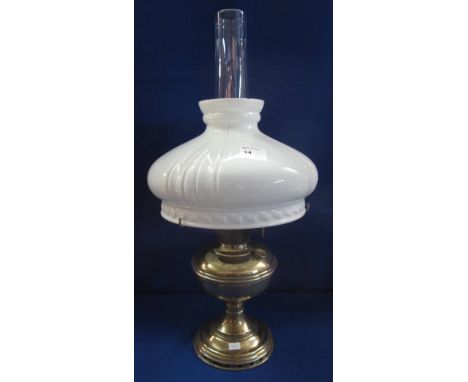 Brass oil lamp with fluted opaque shade and clear chimney.
