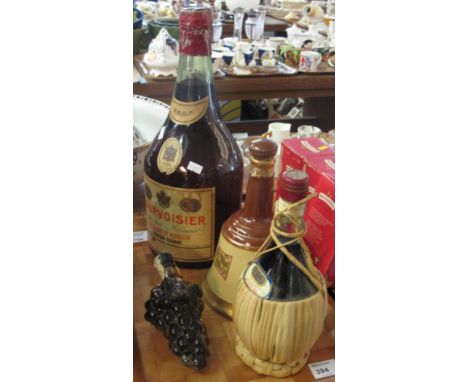 Courvoisier advertising bottle together with a Bell's old scotch whisky decanter, Ruffino and Spanish liqueur bottle in the f