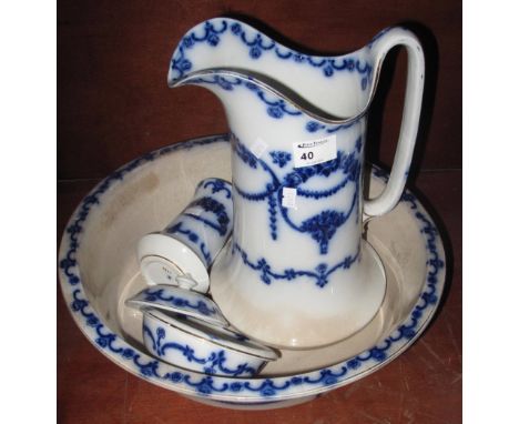 Staffordshire Alma Pottery flow blue decorated jug and basin set with soap dish and toothbrush vase. (4)