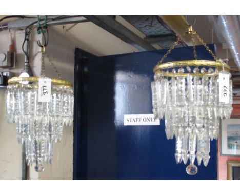 Four circular gilt graduated ceiling light fittings with prismatic drops. (4)