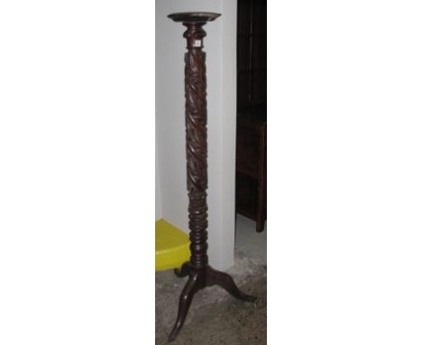Mahogany foliate carved torcher stand on tripod base. 