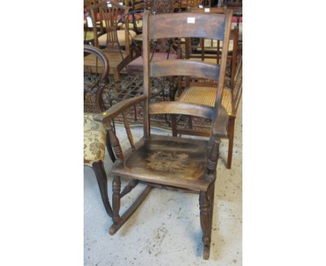 Stained ladder back carver rocking chair.