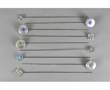 A collection of nine early 20th Century silver and enamel hatpins, all bearing decoration of Indian and East Asian swastika, 