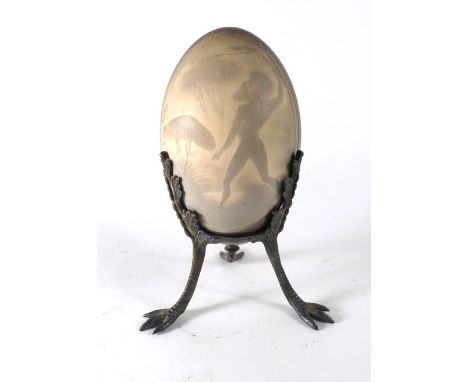A 19th century cameo carved emu egg centrally depicting an Aboriginal figure hunting an emu and supported on a silver plated 