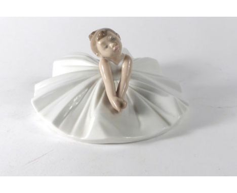 A Nao figure modelled as seated young ballerina, h. 8.5 cm, boxed CONDITION REPORT: No obvious chips, cracks or restoration