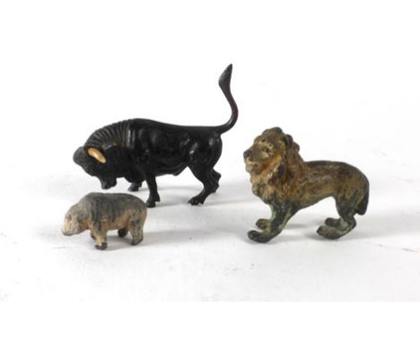 A late 19th/early 20th century cold painted bronze figure modelled as a bull, together with two other cast metal figures COND