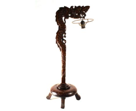 An early/mid 20th century carved hardwood table lamp in the form of a stylised dragon on a circular base, h. 67.5 cm CONDITIO