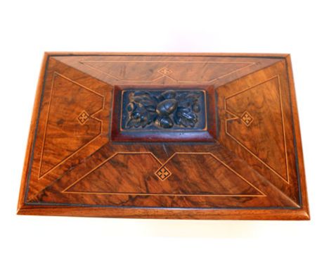 A 19th century walnut and strung tea caddy of sarcophagus form surmounted by an acorn finial, the birch interior with two int