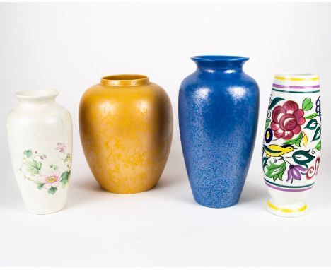 Four Poole Pottery vases including a blue iridescent baluster vase, a gold iridescent swollen baluster vase, an 'LE' pattern 