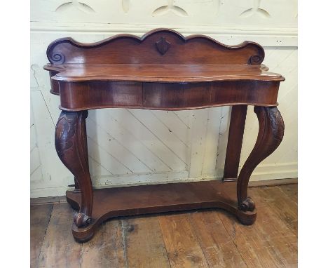 A Victorian serpentine front oak console table, on carved cabriole front legs, with knurl feet, on a platform base, 123 cm wi