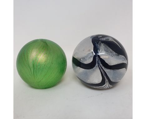 An R Ditchfield Glasform iridescent glass paperweight, of almost spherical form with striated green decoration, signed and in