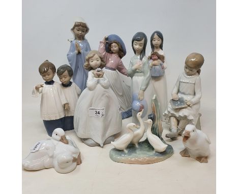 A Nao figure, of a girl in a wide brimmed hat, two other figures, three bird groups, all boxed, and four other Nao figures/gr