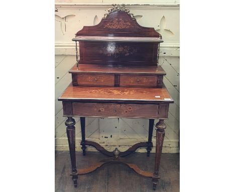 A French rosewood bonheur du jour, with brass mounts, the superstructure with a shelf and two small drawers, the base with a 