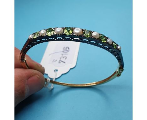 A 9ct gold, silver, periodot and pearl bangle 