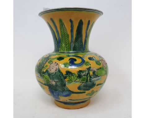 A Chinese yellow ground vase, decorated figures and foliage in green enamel, rim chipped, 12 cm high 
