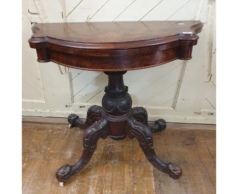 A Victorian card table, the shaped top veneered in burr walnut, on a carved base, 92 cm wide 