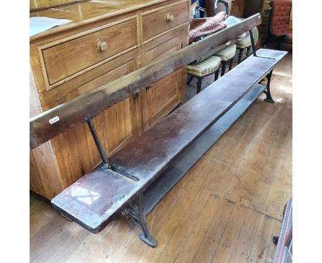 A late Victorian/Edwardian pine and iron tram bench, 273 cm 