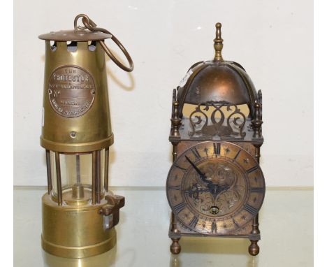 A 19th century brass miner's lamp, a reproduction lantern clock, various other metalwares, and a tripod table 