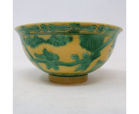 A Chinese yellow ground bowl, decorated figures and foliage in green enamel, 15 cm diametergood condition 