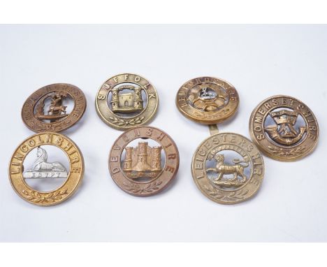 Seven various British army helmet plate centres and pagri badges