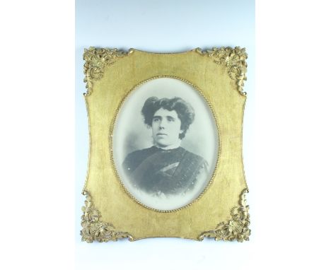 An Edwardian photographic portrait of a lady in an ornate gilt frame, under glass, 36.5 x 29 sight size