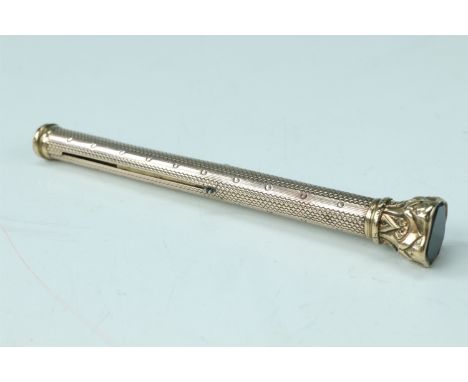 A yellow metal combination propelling pencil and dip pen, having an engine turned barrel and a bloodstone seal top, (tests as