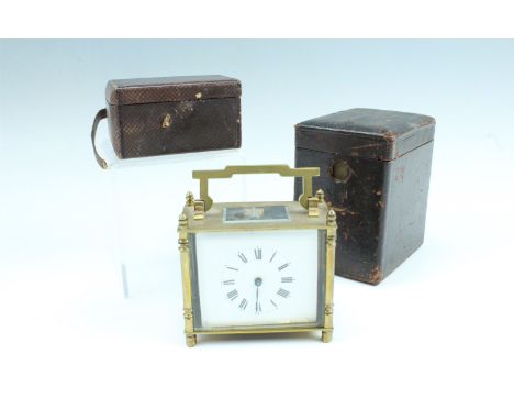 An early 20th Century brass carriage clock, keyless wind, key set, the case having turned corner columns, brass sides and bac