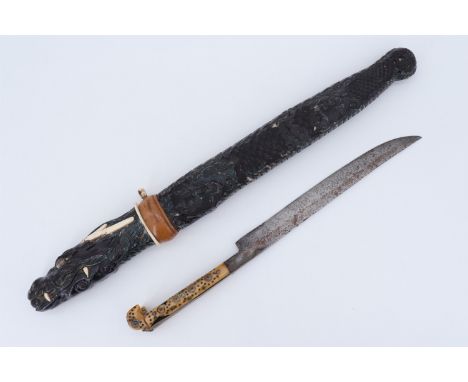 A late 19th / early 20th Century Japanese tanto, having a carved wood scabbard and hilt, a bone tsuba and applied ornament, (