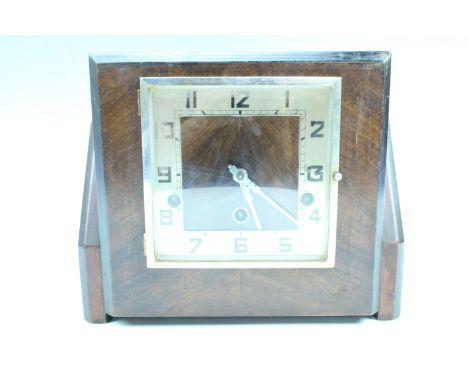 An Art Deco walnut mantle clock by Norland, striking on gongs, having a square dial and stepped sides, key present, 28 x 15 x
