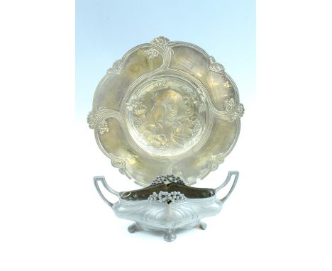 A late 20th Century Art Nouveau influenced cast brass wall plaque, bearing a young lady's portrait among grape and vine, and 