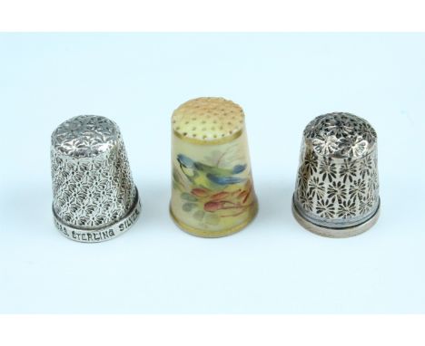 A late 19th / early 20th Century silver thimble, a Sterling standard white metal thimble and a Crown Devon / Worcester style 