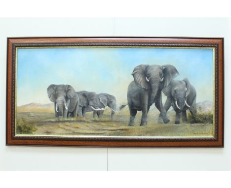 David Wilkinson Oil on canvas, in the style of David Shepherd, of a herd of elephants in a mountainous arid plain underneath 
