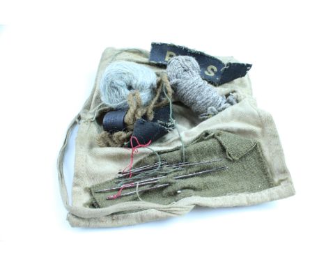 A Second World War British army "housewife" sewing kit including a pair of printed RASC shoulder titles