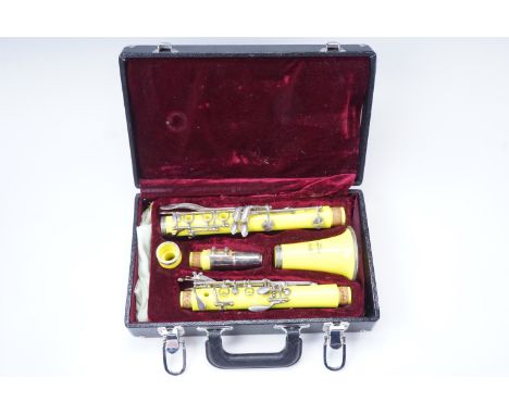 A late 20th Century cased neon yellow five piece clarinet by 'DY Musical Design in USA'