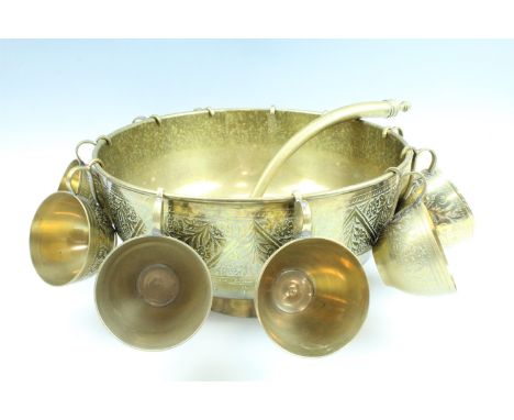 A large late 20th Century Indian brass punch bowl and cups, with an associated brass ladle, diameter 33 cm 