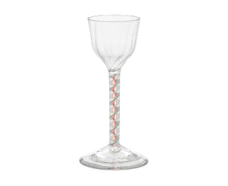 A rare red and green colour twist wine glass, circa 1765The ogee bowl moulded with eight evenly spaced vertical ribs, on a st