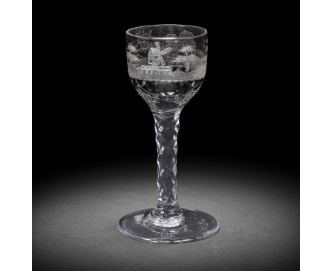 An engraved facet stem wine glass, circa 1775-80The ovoid bowl cut with thumbnail facets around the base, decorated with a co