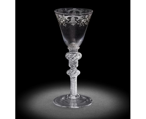 A fine engraved light baluster wine glass, circa 1750The round funnel bowl decorated with a rocaille border of elaborate foli